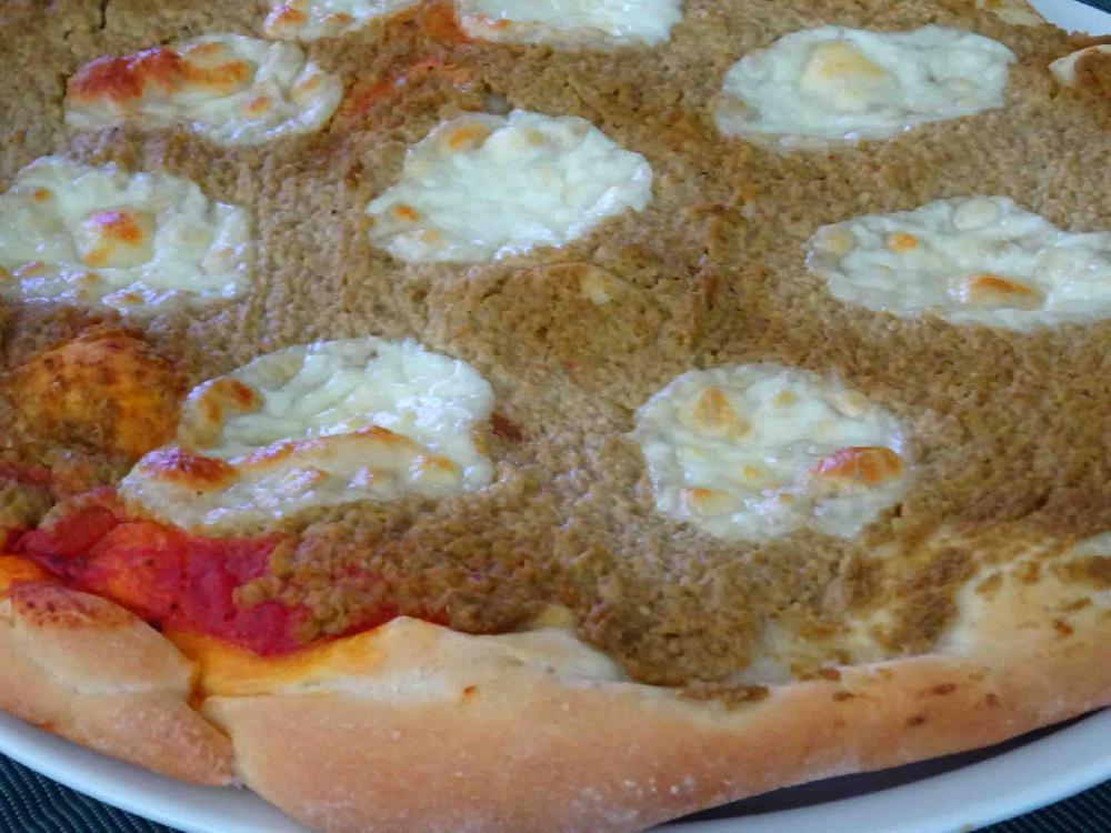 Pizza with olive dip and mozzarella cheese
